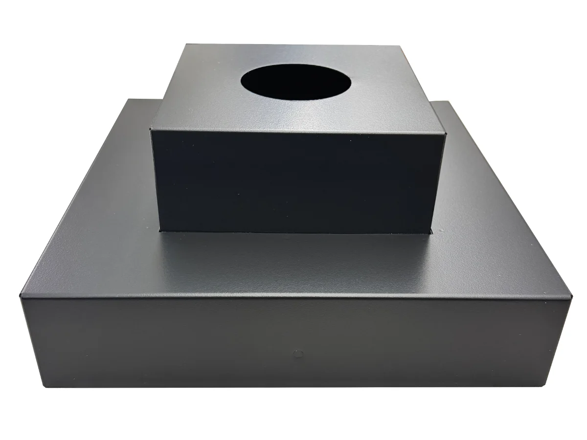 Dark gray metal base with a raised square block on top that has a circular hole in its surface.